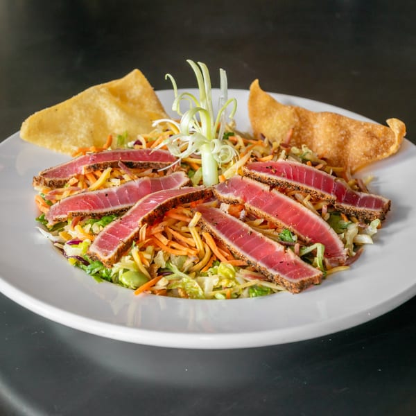 Asian crunch salad with seared rare ahi tuna, shredded veggies, and crispy wontons.
